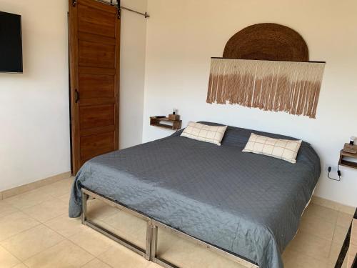 a bedroom with a bed with a blue comforter at Alojamiento en el centro de Salta - Casaguemessalta in Salta