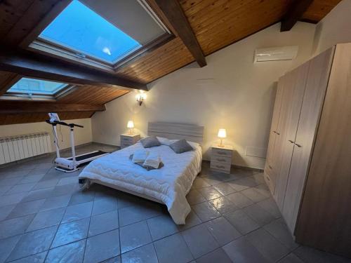 a bedroom with a large bed and a skylight at IL PALAZZO - Luxury Home & Event in Cosenza