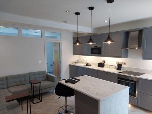 a kitchen with blue cabinets and a counter top at Jester Court - 2 bed apartment in the Centre of Windermere Village - FREE off-site Health Club access with Pool, Sauna, Steam Room & Gym in Windermere