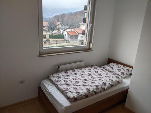 a bed in a room with a window at Banja luka Apartmans in Banja Luka