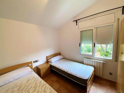 A bed or beds in a room at Bright Villa in Vidreres with Private Pool and Jacuzzi