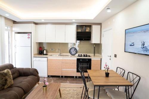 a kitchen and living room with a couch and a table at ABC Apart Hotel in Antalya