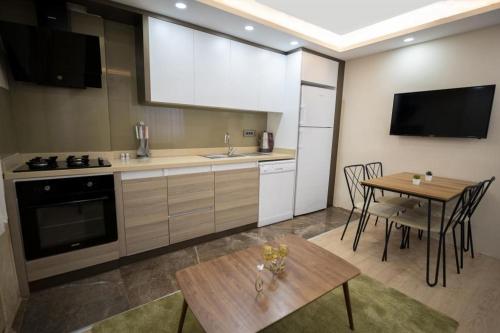 a kitchen with a table and a dining room at ABC Apart Hotel in Antalya