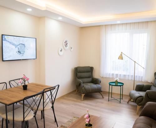 a living room with a table and chairs at ABC Apart Hotel in Antalya