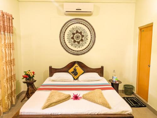 a bedroom with a bed and a plate on the wall at Sigiri Choona Lodge 'unique sunrise viewpoint' in Sigiriya