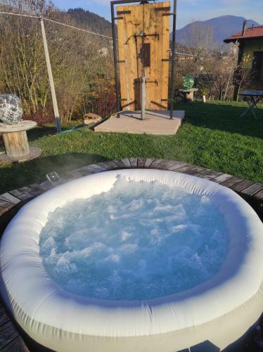 a large hot tub in a yard with aificialificialificialificialificialificialificial at Agriturismo La Soglia Del Parco in Ranica