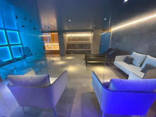 a living room with couches and chairs and blue lights at Villa Ghiandai in Arezzo