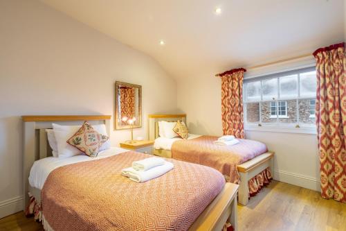 a bedroom with two beds and a window at Apartment 4 - The Kings in York