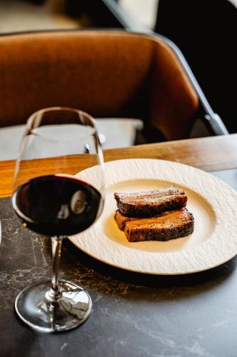 a plate of food next to a glass of wine at Ta' Tereza In Manwel Dimech in Sliema
