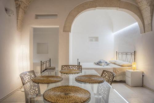 Habitación con mesa, sillas y cama en Home Pedra, en Ceglie Messapica