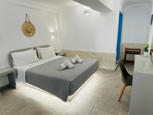 a bedroom with a bed with two towels on it at Perissa Bay in Perissa
