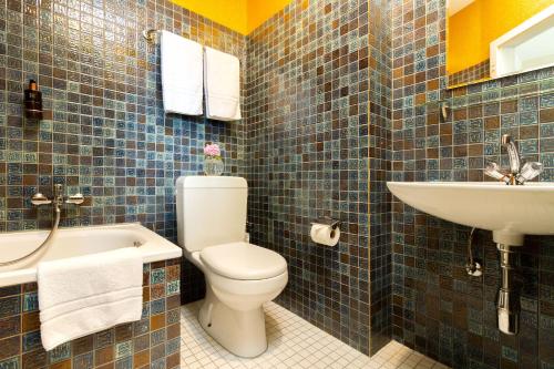 a bathroom with a toilet and a sink at Hotel Beau Séjour Lucerne in Luzern