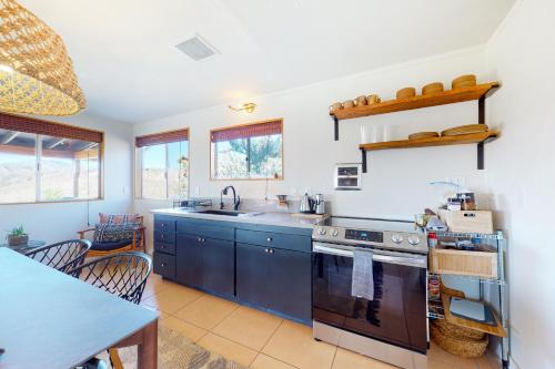 a kitchen with a sink and a stove at Wowanka Paradise in Yucca Valley