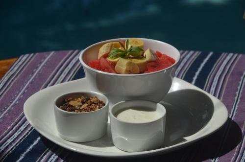 a plate with a bowl of food on a table at Nuestra Casa in San Juan del Sur