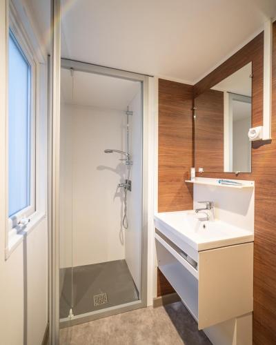 a bathroom with a white sink and a shower at Centro Vacanze - Garden River in Altidona