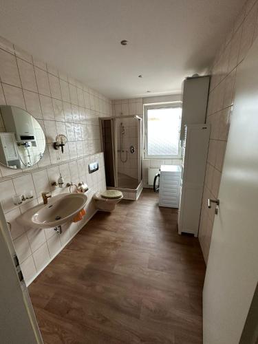 a bathroom with a sink and a toilet at Pension am Teutoburger Wald in Georgsmarienhütte