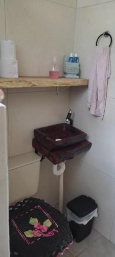 a bathroom with a wooden sink and a towel at Cabana rustica logcabin com banheira aquecida in Osório