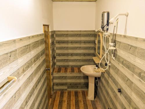a bathroom with wooden floors and a sink at Sigiri Choona Lodge 'unique sunrise viewpoint' in Sigiriya