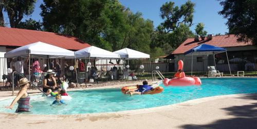 a group of people playing in a swimming pool at Rancho Santa Cruz in Tubac