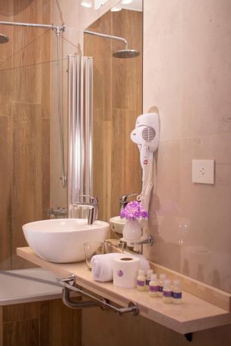 a bathroom with a sink and a mirror at Las Hortensias Hotel in Monteros