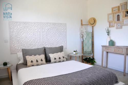 a bedroom with a large bed in a room at Mar à Vista Burgau in Burgau