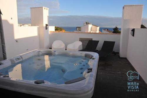 a jacuzzi tub on the balcony of a house at Mar à Vista Burgau in Burgau