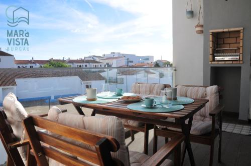 a table and chairs on a balcony with a view at Mar à Vista Burgau in Burgau