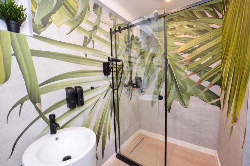 a bathroom with a glass shower and a toilet at One by One - by Grand Accommodation in Bucharest