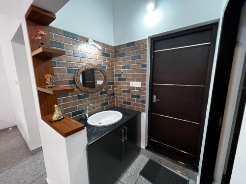 a bathroom with a sink and a mirror at Munnar Home stay in Munnar