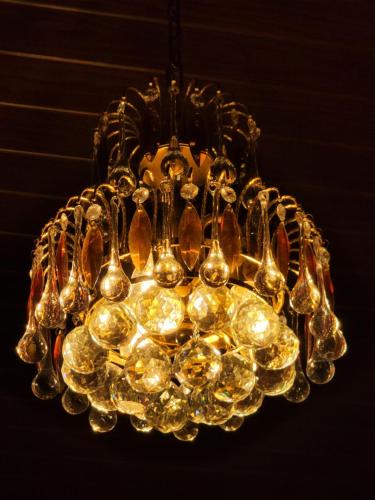 a glass chandelier hanging from a ceiling at Cherry blossom homestays Munnar 2BHK in Munnar