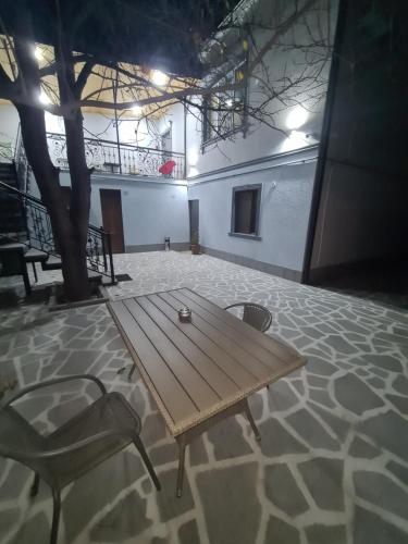 a wooden table and a chair in a room at KHORGO in Gori