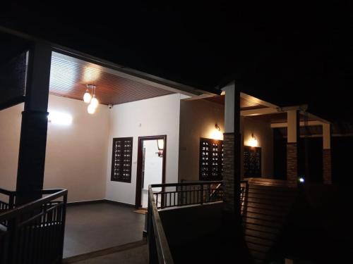 a dark room with a staircase leading into a building at Cherry blossom homestays Munnar 2BHK in Munnar