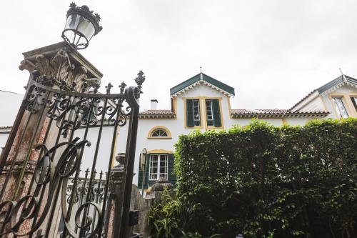 a wrought iron gate in front of a house at Casa da Tia Luísa in Furnas