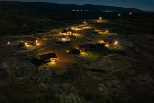 an aerial view of a village at night with lights at Alma Serrana - Suites de montaña! in La Cumbrecita