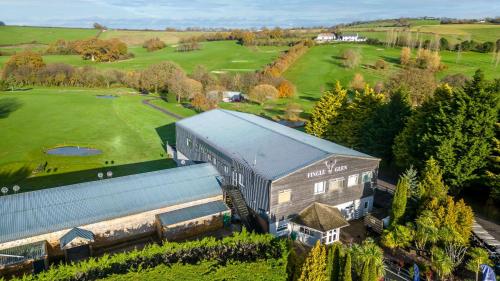 an aerial view of a building and a golf course at Chestnut, 6 Fingle Glen Lodges in Holcombe Burnell