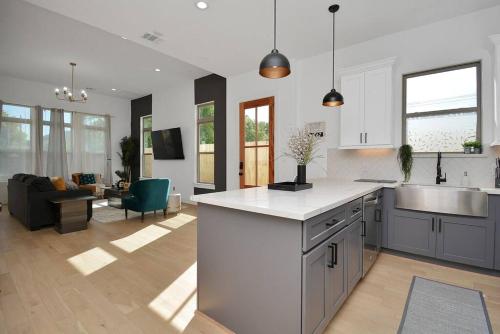 a kitchen and living room with a sink and a counter at Blissful Getaway Home with Hot Tub & Backyard Near Downtown in Houston