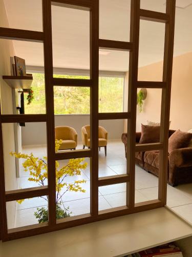 Habitación con una gran ventana de cristal en la sala de estar. en Ap 2 quartos em Ipiabas, en Barra do Piraí