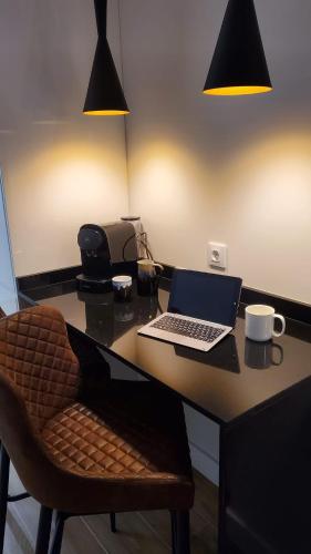 a desk with a laptop computer on top of it at Cíes Luxury Suitel Lily Rodsen - Love your Stay in Vigo
