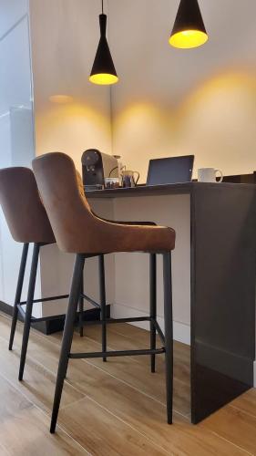 a chair sitting in front of a desk with a laptop at Cíes Luxury Suitel Lily Rodsen - Love your Stay in Vigo