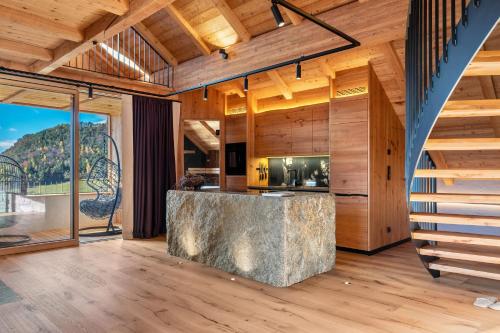a kitchen with wooden walls and wooden flooring at Spornberg Mountain Living Nordberg in Soprabolzano