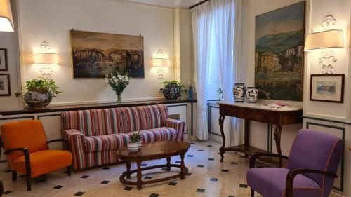 a living room with a couch and a table and chairs at Hotel Villa Di Sorrento in Sorrento