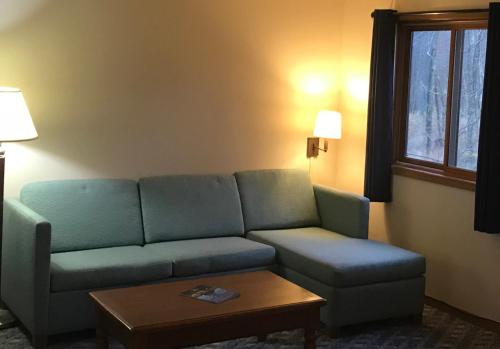 a living room with a couch and a coffee table at Village Inn on the Lake in Two Rivers