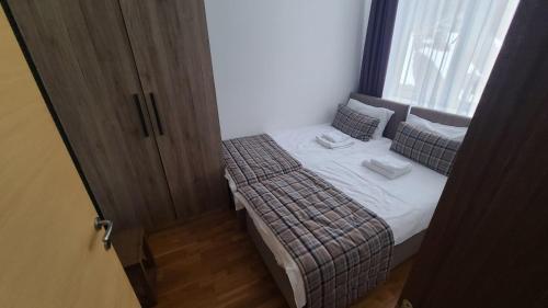 a small bedroom with a bed and a window at Kolakovic in Brzeće