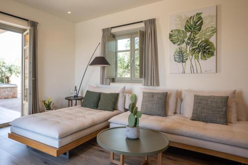 a living room with a couch and a table at Katergo Luxury Villas in Stoupa