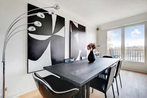 - une salle à manger avec une table, des chaises et un vase fleuri dans l'établissement Wonderfull apartment - 1BR-6P - Eiffel Tower, à Paris