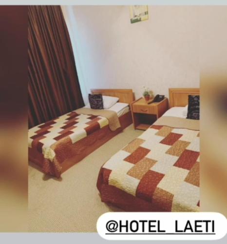 a hotel room with two beds and a hotel left at Laetu in Atyraū