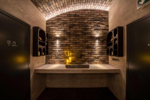 a fireplace in a room with a brick wall at The Viaduct - Suites & More in Prague