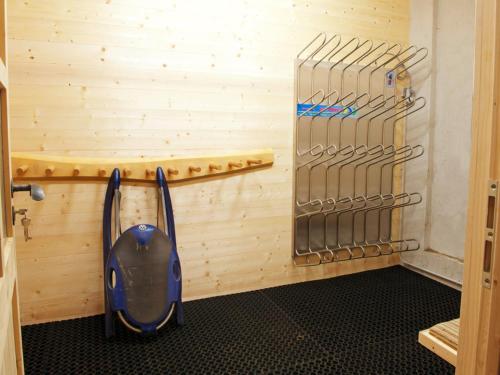 a room with a wooden wall with a blue vacuum at Kometer App Edelweiss in Fendels