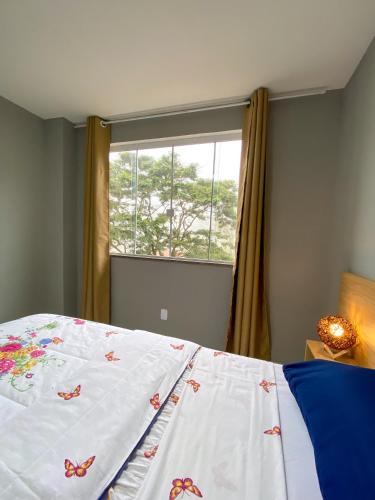 1 dormitorio con 1 cama con mariposas en las sábanas en Apartamento de 01 quarto, novíssimo, em Ipiabas., en Barra do Piraí