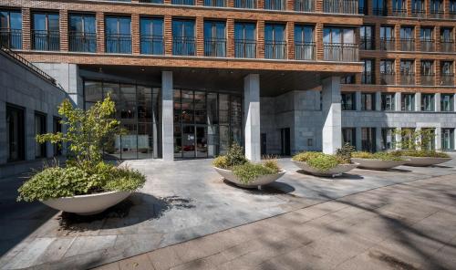 a building with a row of planters in front of it at STUDIO ROTTERDAM Cntr in Rotterdam